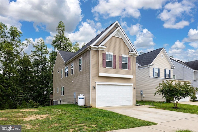 view of front facade with a front yard, central AC, and a garage