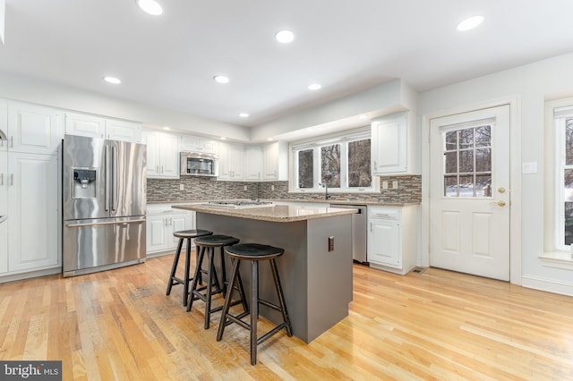 kitchen featuring appliances with stainless steel finishes, a center island, and white cabinets