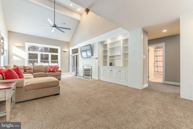 living room featuring high vaulted ceiling, carpet flooring, built in features, ceiling fan, and beam ceiling