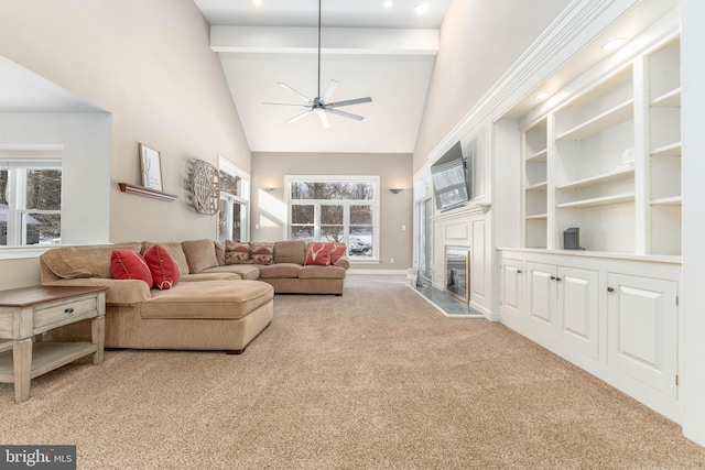 carpeted living room featuring beamed ceiling, ceiling fan, a premium fireplace, and high vaulted ceiling