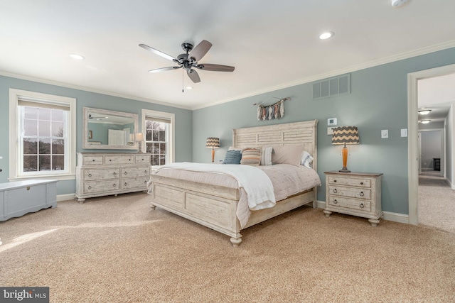 bedroom with crown molding, light colored carpet, and ceiling fan