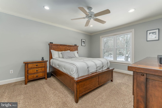 carpeted bedroom with ornamental molding and ceiling fan