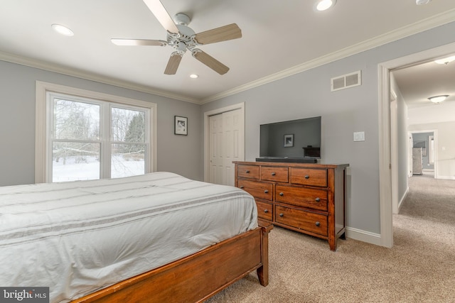 carpeted bedroom featuring ceiling fan, ornamental molding, and a closet