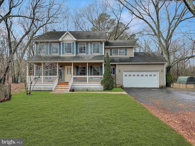 view of front of house featuring a porch, a front lawn, and a garage