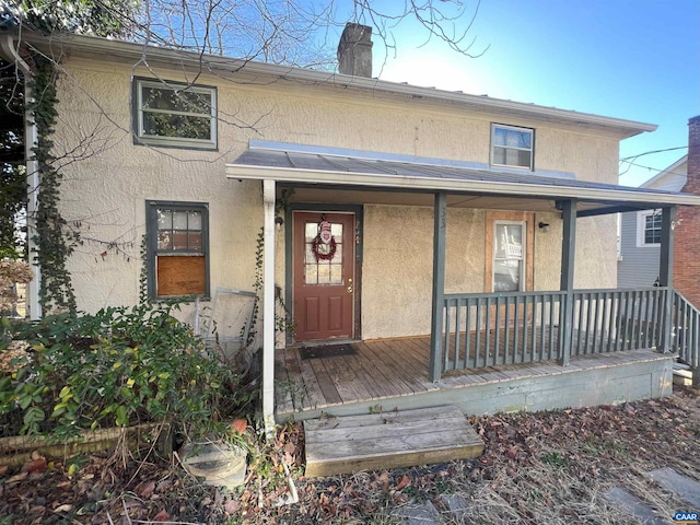 rear view of property featuring a porch