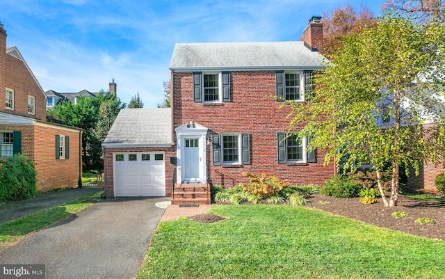 view of front of property with a front lawn and a garage