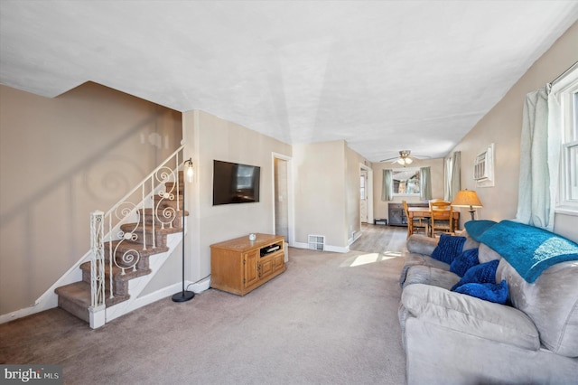 carpeted living room with ceiling fan