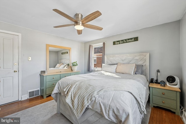 bedroom featuring ceiling fan and dark hardwood / wood-style floors