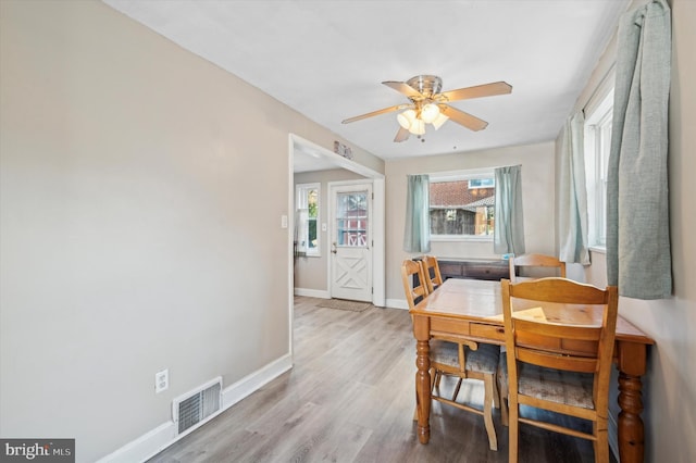 dining area with ceiling fan and light hardwood / wood-style floors