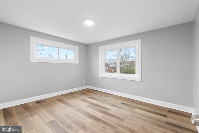 empty room with light hardwood / wood-style flooring