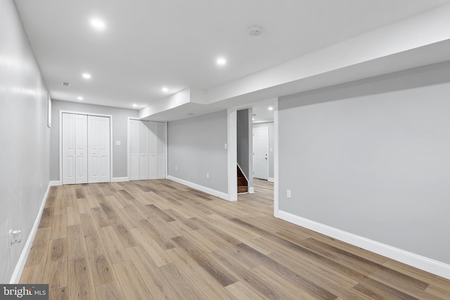 basement with light hardwood / wood-style flooring