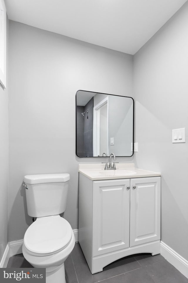 bathroom with tile patterned floors, vanity, and toilet