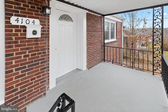 view of exterior entry with covered porch