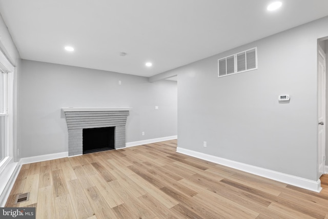 unfurnished living room featuring light hardwood / wood-style floors and a fireplace