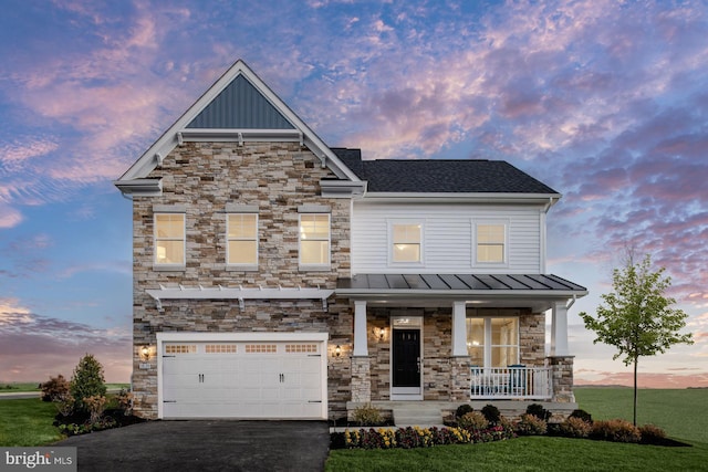 craftsman inspired home with a lawn, a porch, and a garage