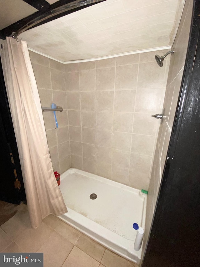 bathroom featuring a shower with curtain and tile patterned flooring