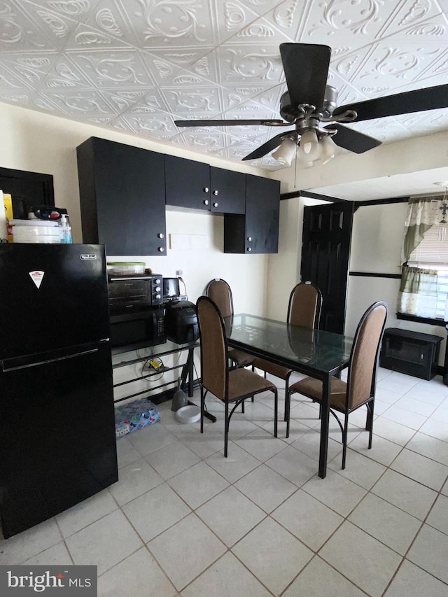 dining area featuring ceiling fan and light tile patterned floors