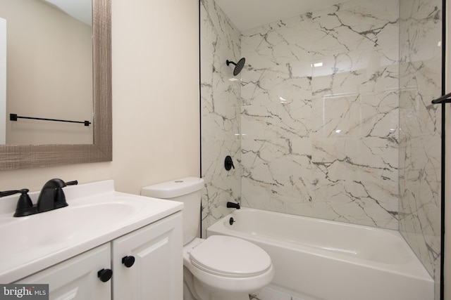 full bathroom featuring toilet, vanity, and tiled shower / bath