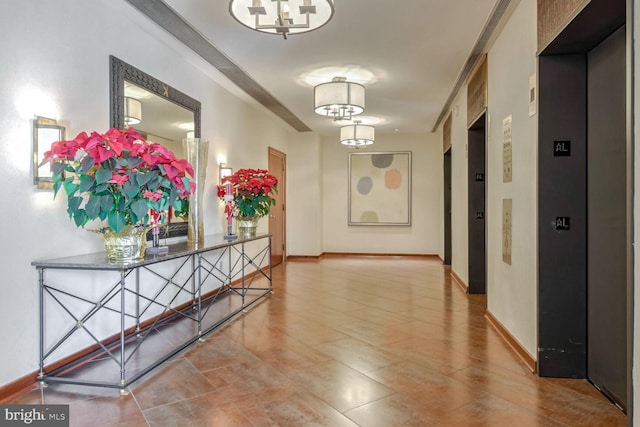 hall with a chandelier and elevator