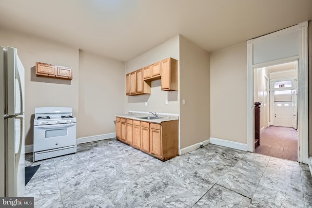 kitchen featuring sink and white appliances