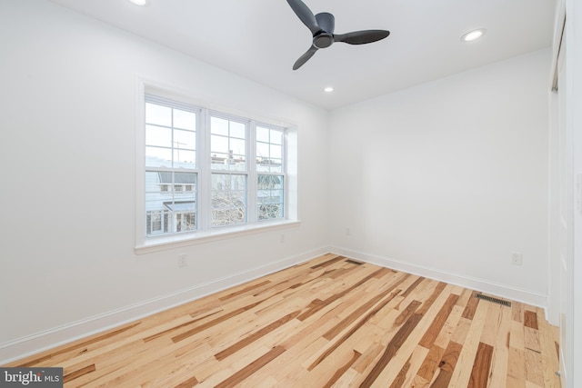 spare room with light hardwood / wood-style flooring and ceiling fan