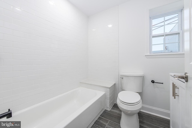 bathroom with toilet and a tub