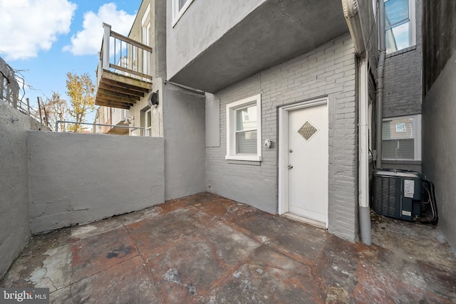 entrance to property with a patio and central AC unit