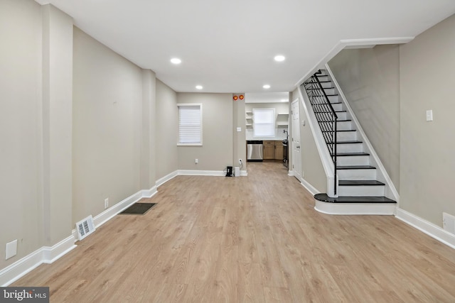 basement with light hardwood / wood-style flooring