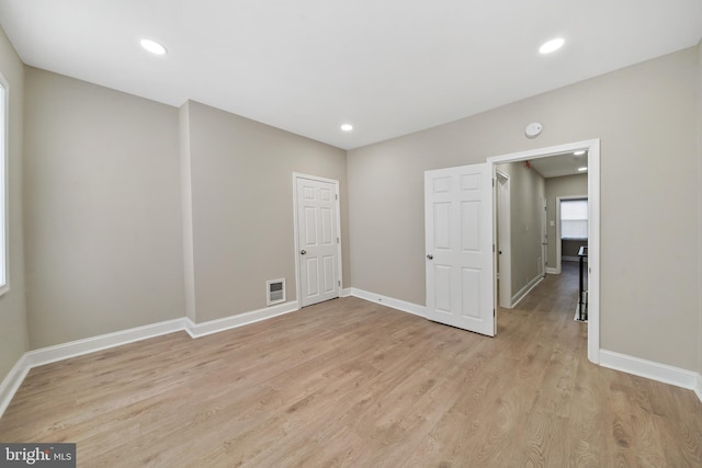 spare room with light hardwood / wood-style flooring