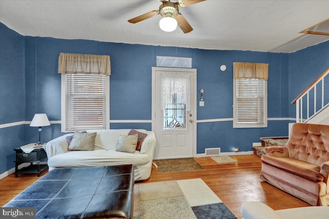 living room featuring hardwood / wood-style flooring, a wealth of natural light, and ceiling fan