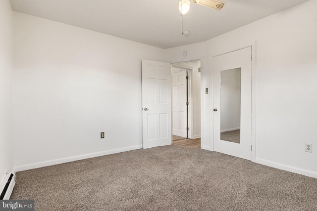 unfurnished bedroom with carpet flooring, ceiling fan, and a baseboard heating unit