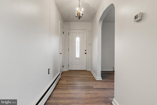 foyer entrance featuring dark hardwood / wood-style floors and a notable chandelier