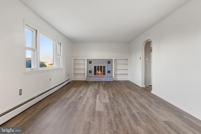 unfurnished living room featuring light hardwood / wood-style floors and a baseboard heating unit