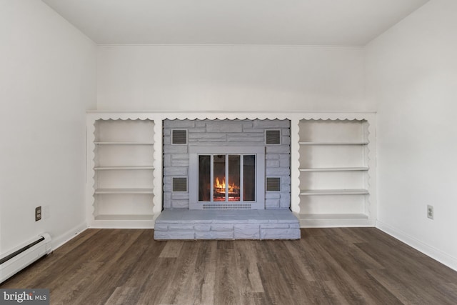 unfurnished living room featuring dark hardwood / wood-style floors, built in features, a fireplace, and a baseboard heating unit