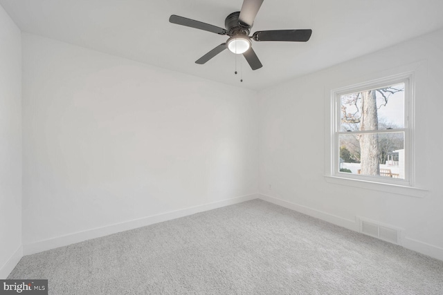 spare room featuring carpet flooring and ceiling fan