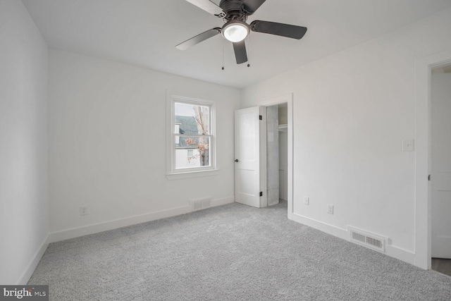 unfurnished bedroom featuring light carpet and ceiling fan