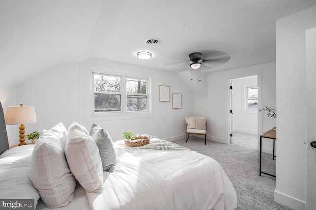 bedroom featuring ceiling fan, light colored carpet, and lofted ceiling