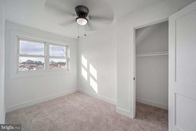 unfurnished bedroom with a closet, light colored carpet, and ceiling fan