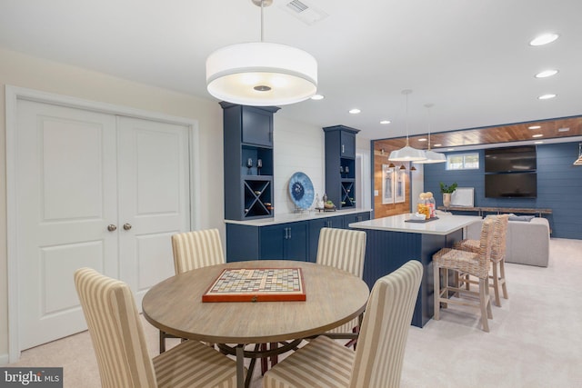 dining area featuring light colored carpet