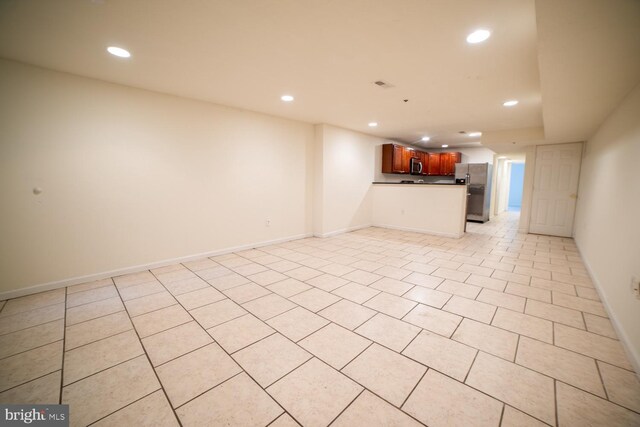 unfurnished living room with light tile patterned floors