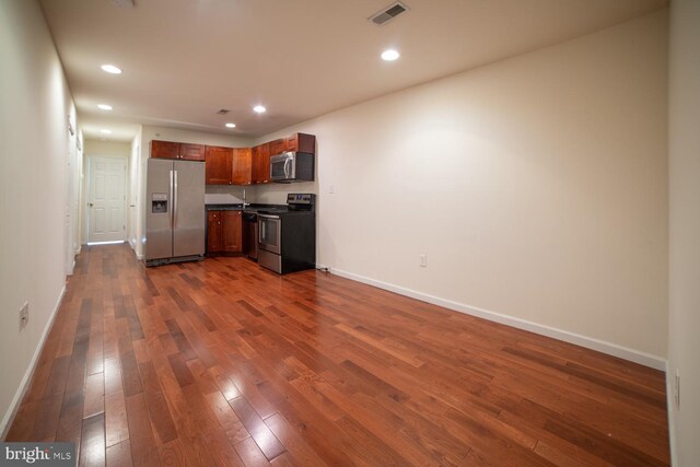 kitchen featuring stainless steel appliances and dark hardwood / wood-style floors