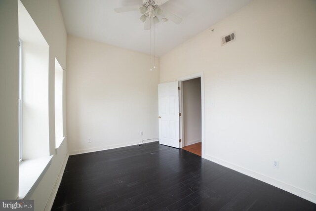 empty room featuring ceiling fan and dark hardwood / wood-style flooring