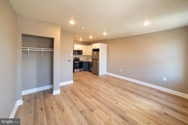 unfurnished living room featuring light hardwood / wood-style floors