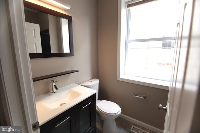 bathroom with vanity and toilet