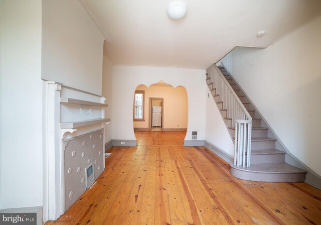 unfurnished living room with light wood-type flooring