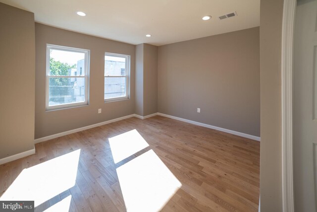 unfurnished room with light hardwood / wood-style floors