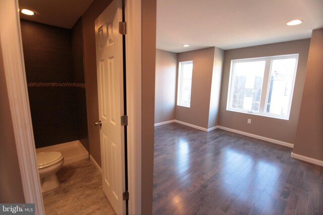 bathroom featuring hardwood / wood-style floors and toilet