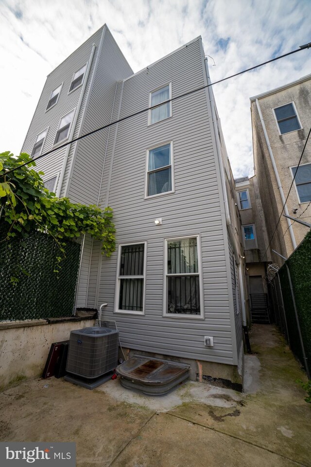 rear view of house featuring central AC unit