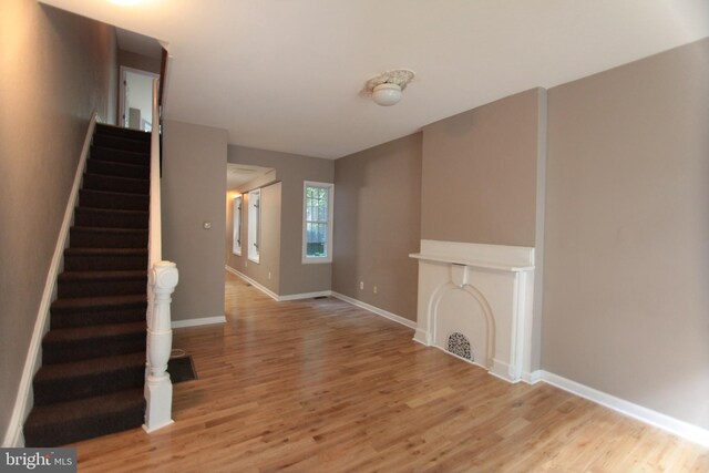 unfurnished living room with light hardwood / wood-style flooring