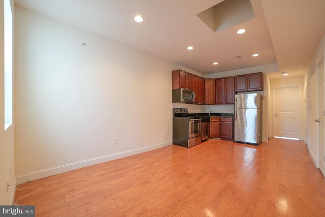 kitchen with light wood-type flooring and appliances with stainless steel finishes